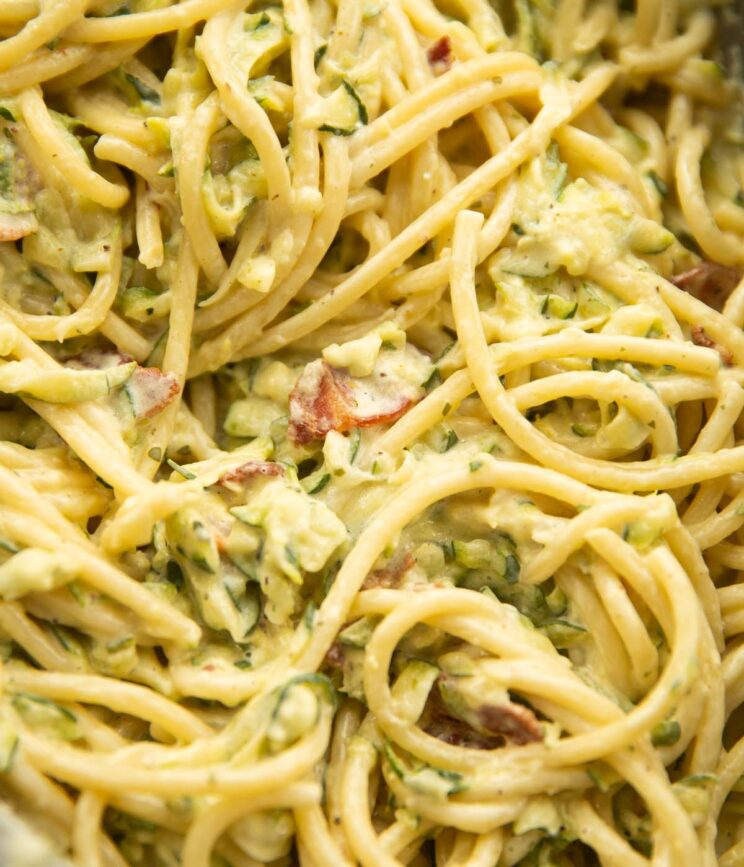 creamy courgette bacon close up overhead shot of creamy courgette bacon pasta in pan